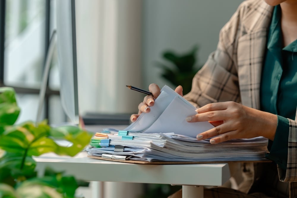 Person using tablet and stylus – managing construction and event projects digitally.