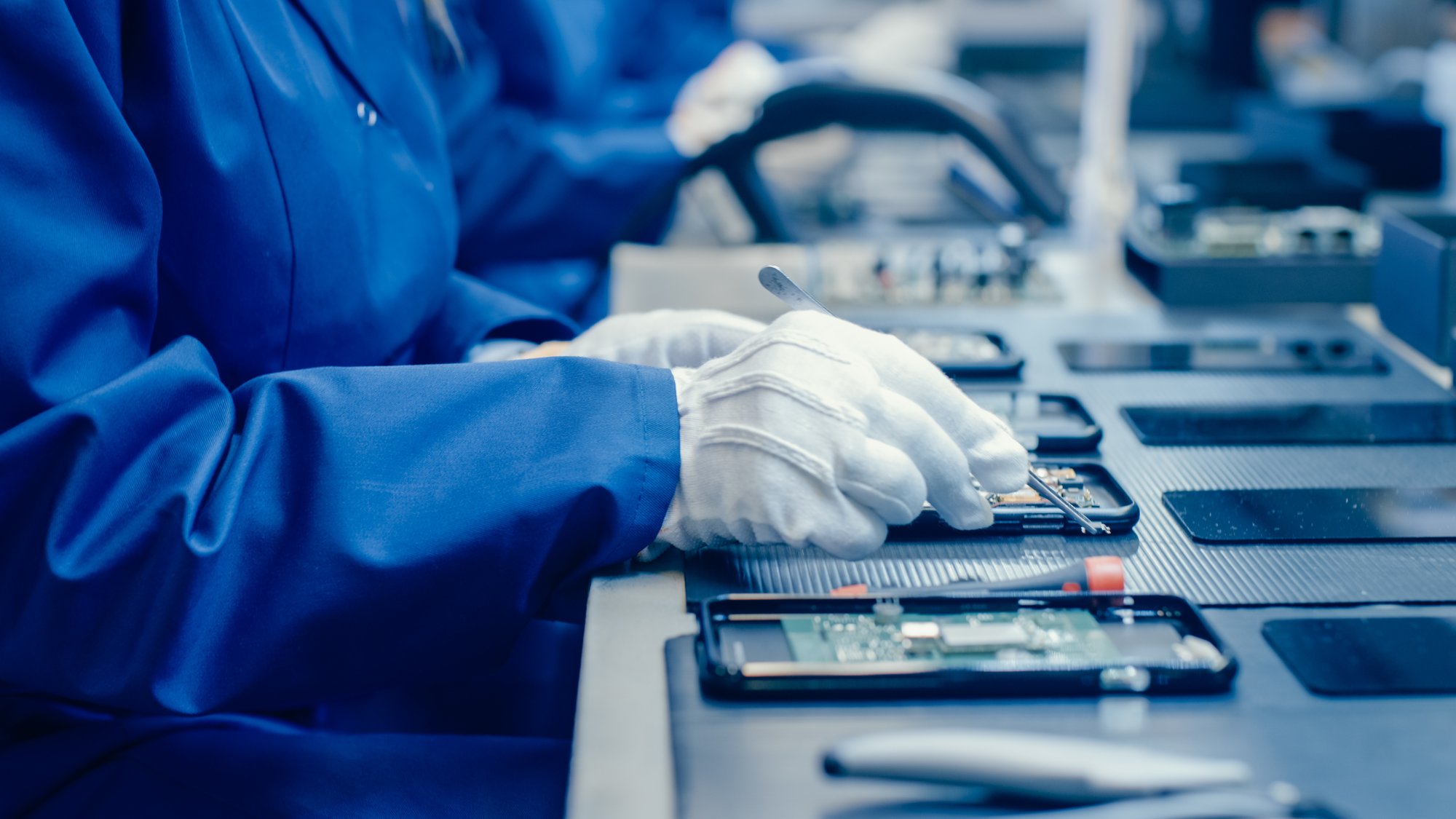 Technician organizing electronic components – challenges in retail asset data consistency.