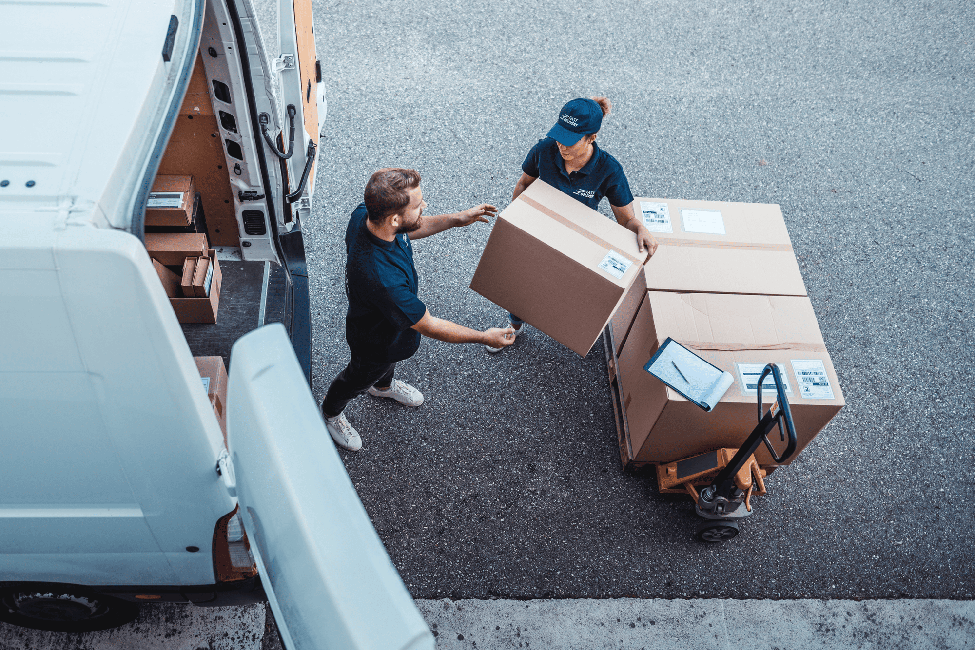 Workers unloading packages from a delivery van – logistics and asset flow in automotive