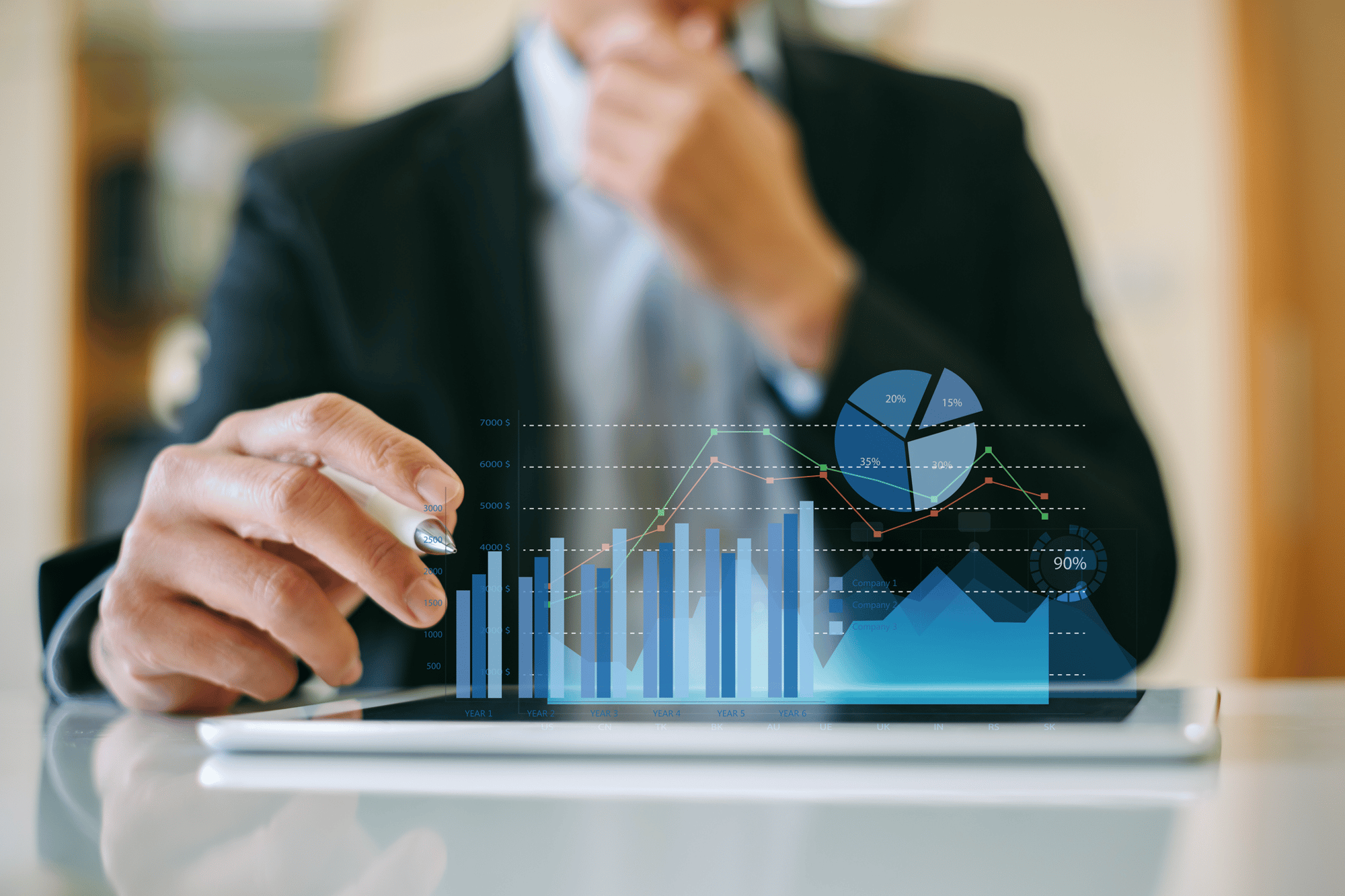 Businessman analyzing smart charts on tablet – data-driven decision-making with EAM.