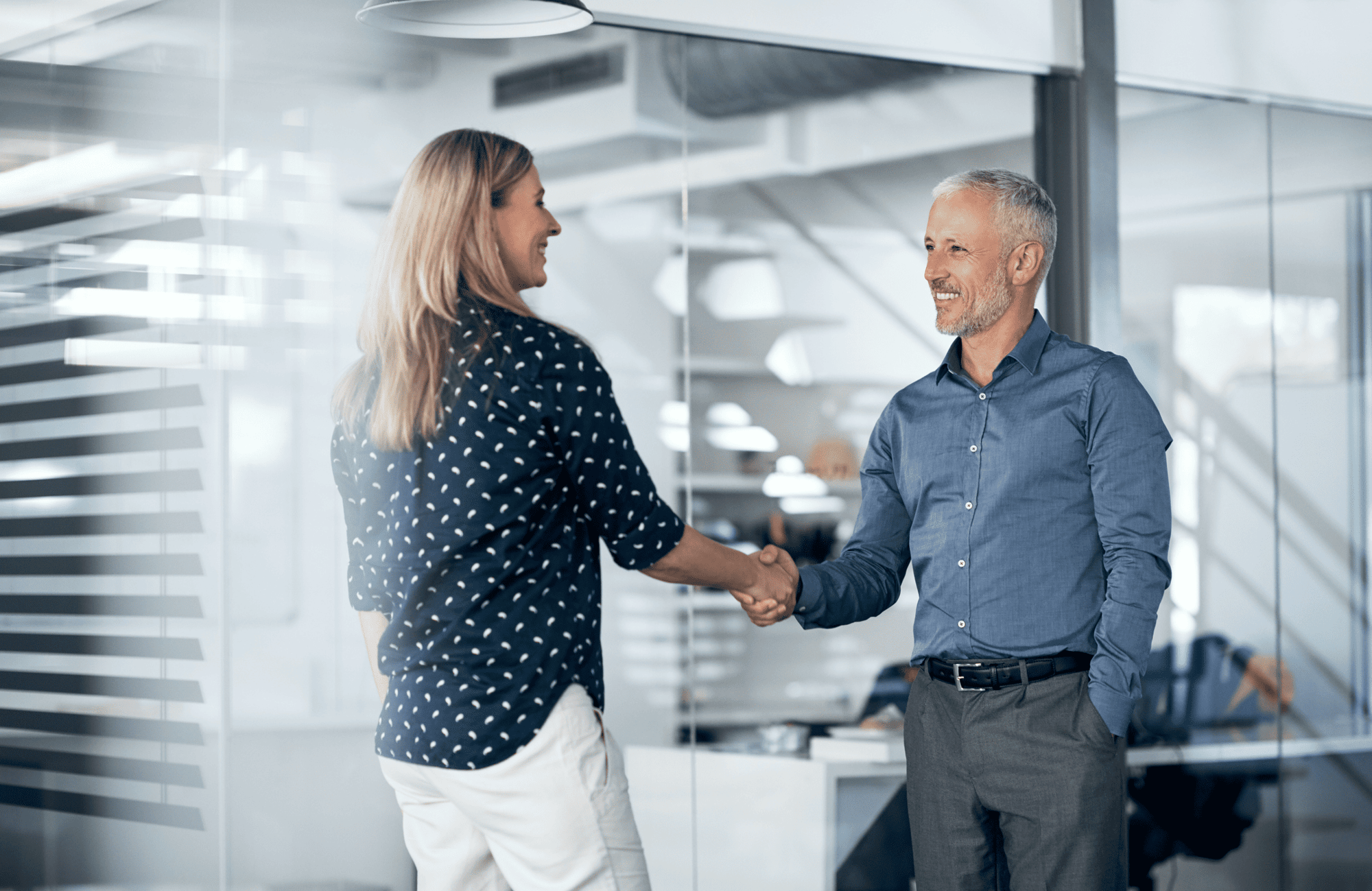 Professionals in discussion at modern office – centralized operational control in real time.
