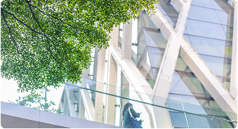 Glass facade building with greenery – ESG and sustainability in utilities.