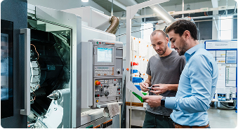 Engineers reviewing industrial equipment data to ensure compliance with regulatory standards