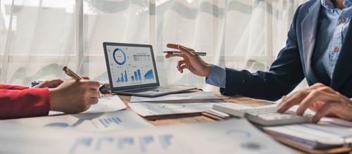 Businessman discuss project planning with colleague at modern workplace while having conversation and advice on financial data report